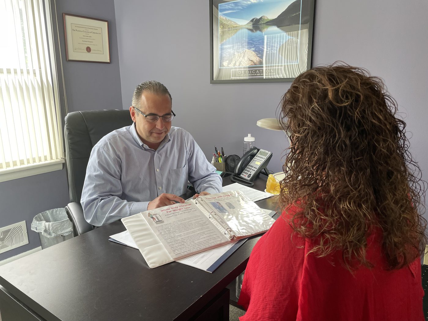 Dr. Augello reviewing a personalized weight loss program with a patient at his Bethlehem PA practice.